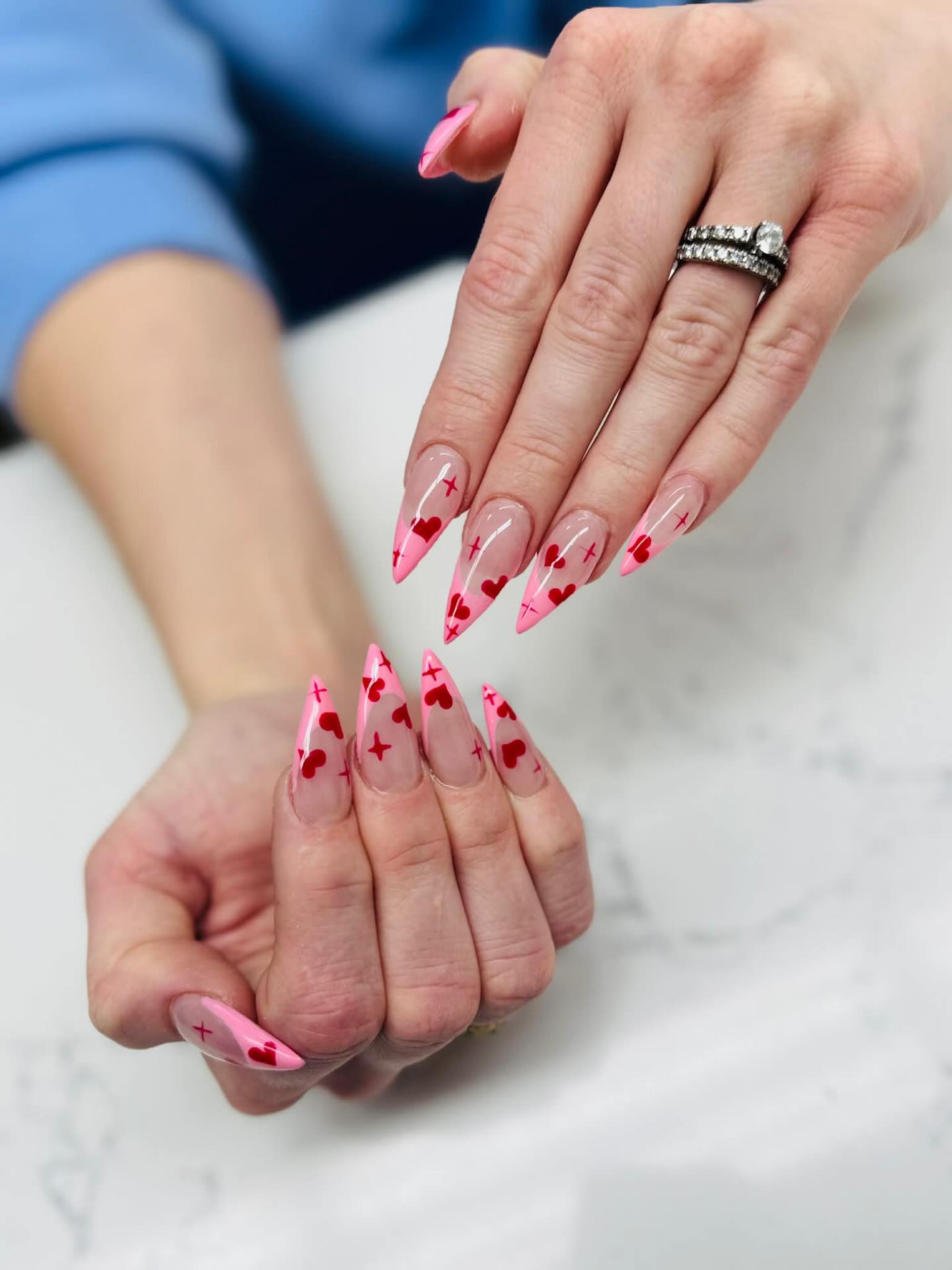 Pink stiletto nails with heart nail art